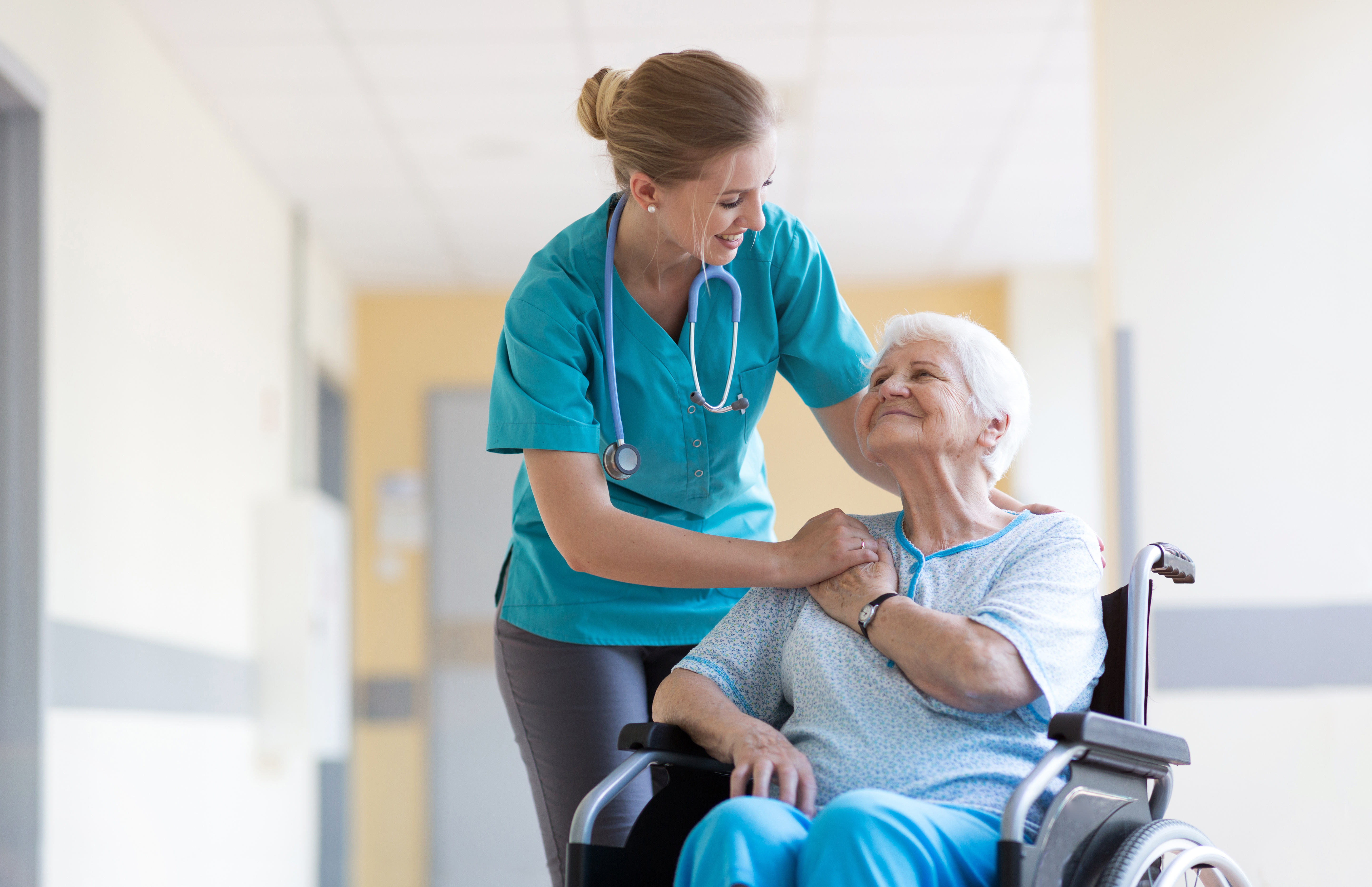 Senior Woman In Wheelchair With Nurse In Hospital Primerdesign Real